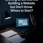 A designer at a desk mapping out a new website layout on paper and laptop, representing the process of starting a business website.